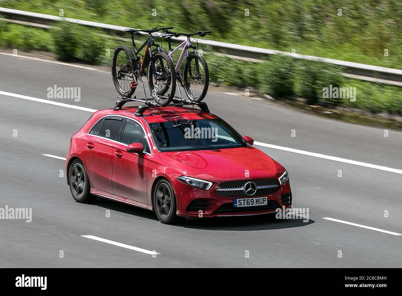 2019 red Mercedes-Benz A 180 AMG Line Executive driving on the M6motorway near Preston in Lancashire, UK Stock Photo