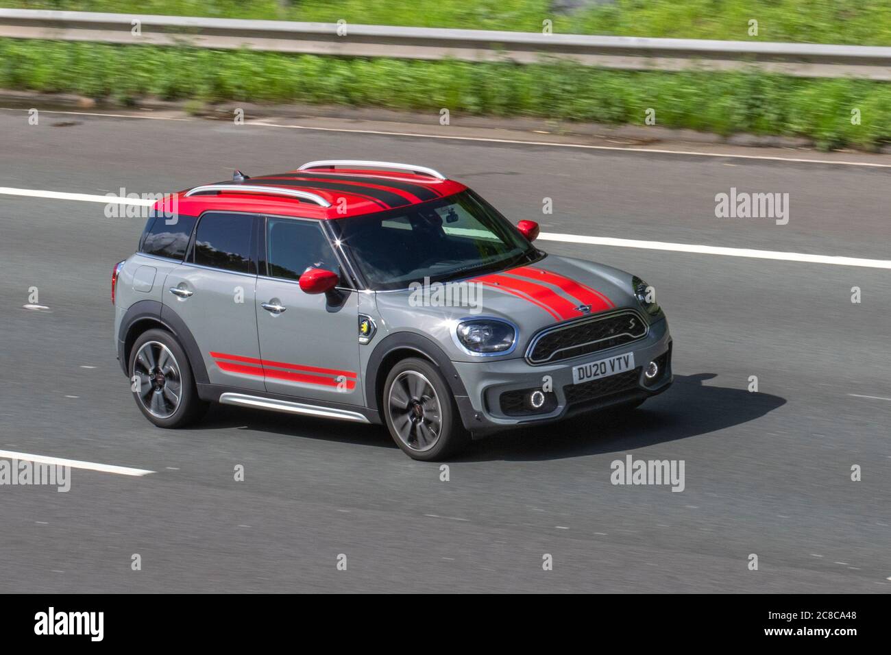 2020 grey red Mini C-Man Cooper S E All4  plug-in hybrid; Vehicular traffic moving vehicles, cars driving vehicle on UK roads, motors, motoring on the M6 motorway highway network. Stock Photo