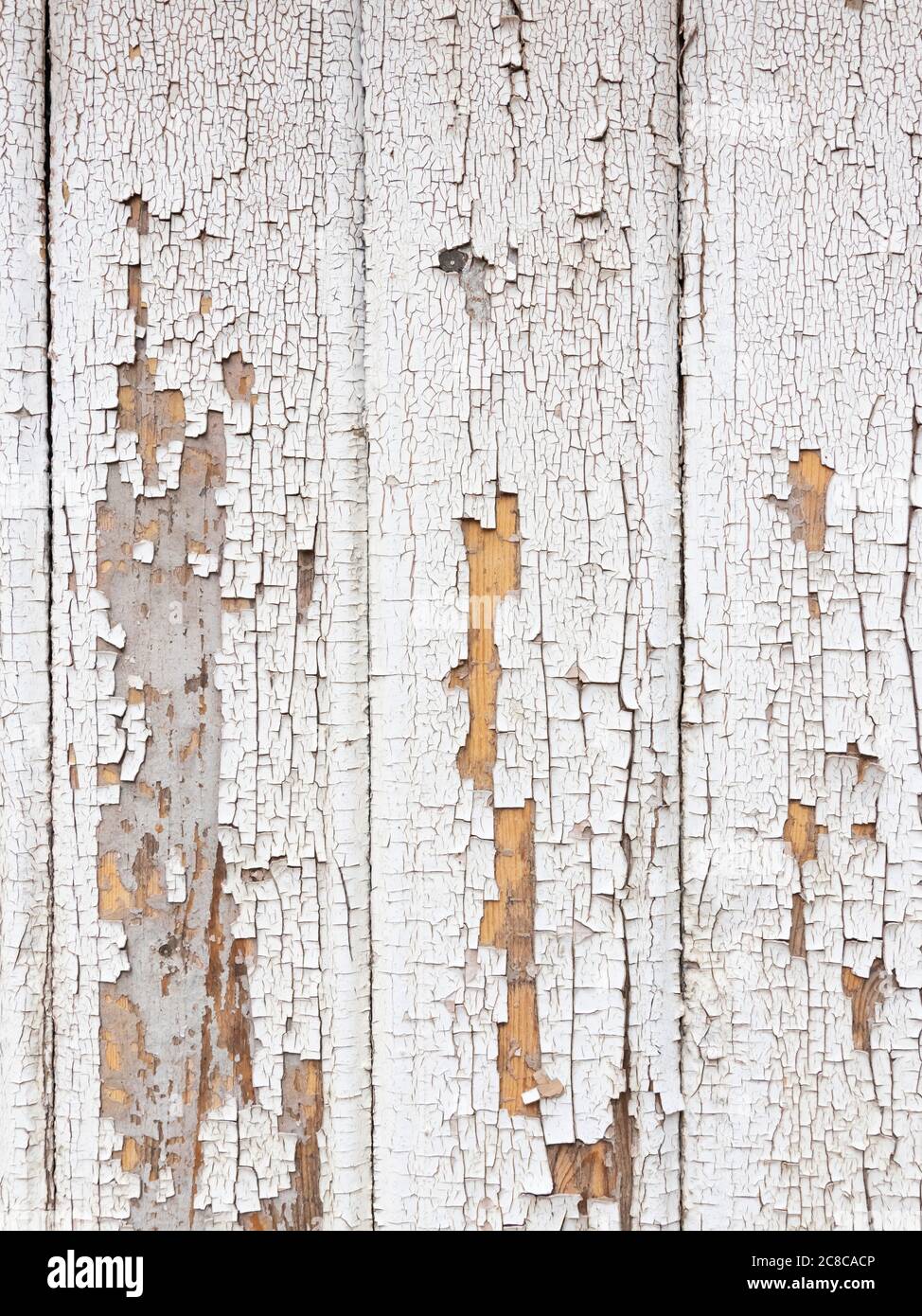 background wooden board with cracked peeling white paint, texture Stock Photo