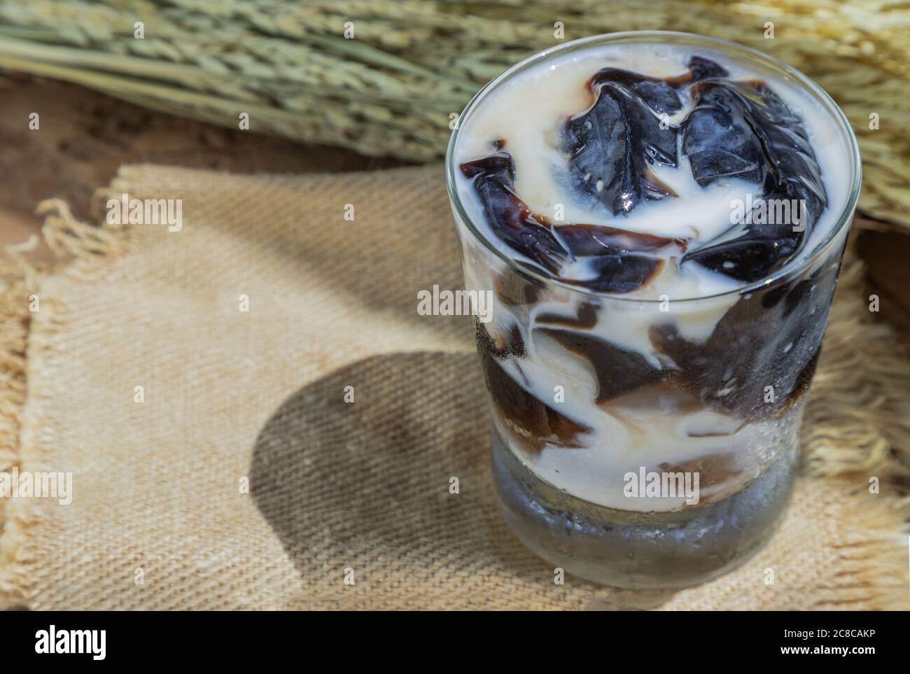 A Glass of Fresh milk grass jelly Dessert herbal gelatin or Jelly black