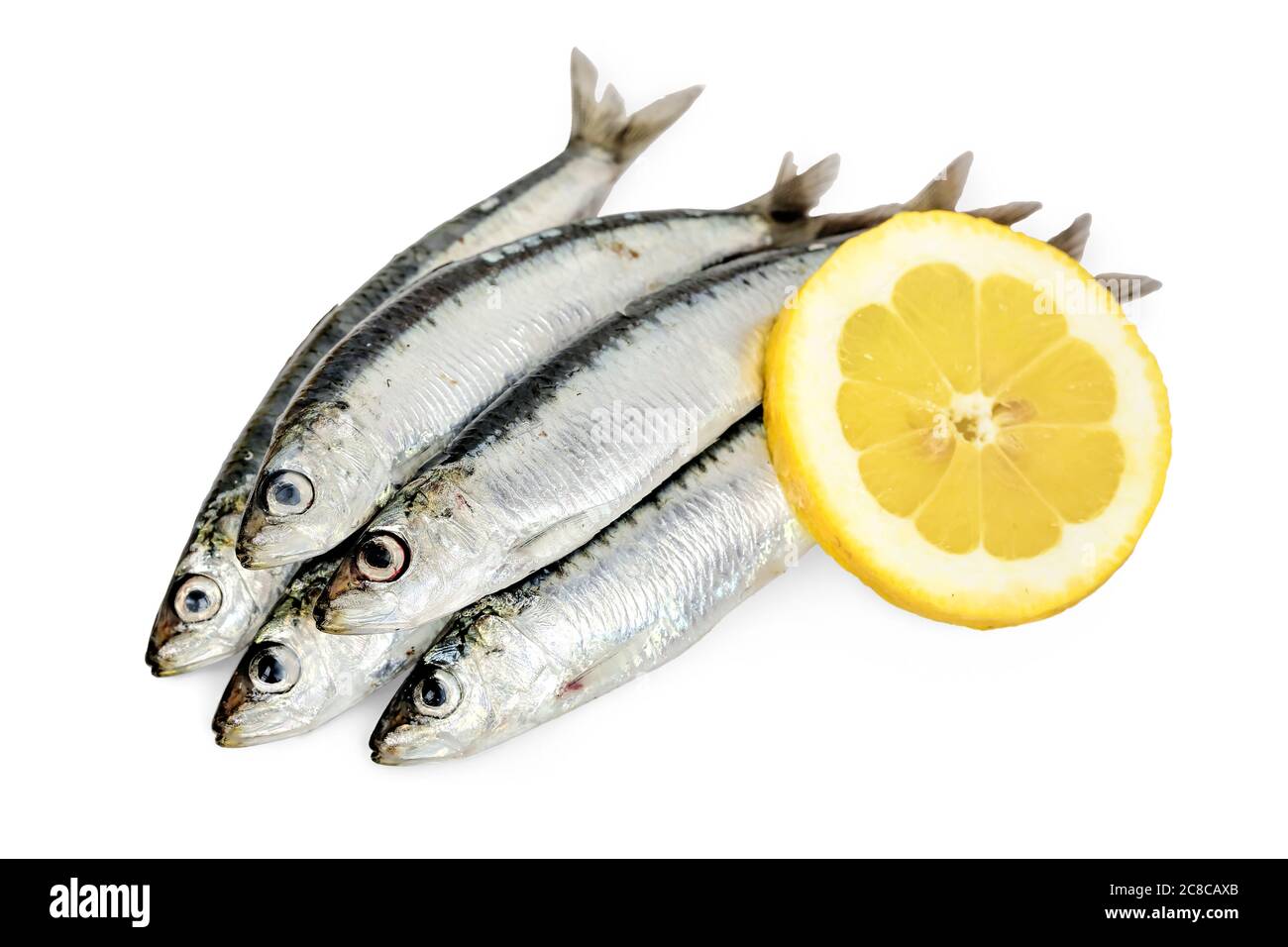 raw sardines with lemon slice on white Stock Photo Alamy