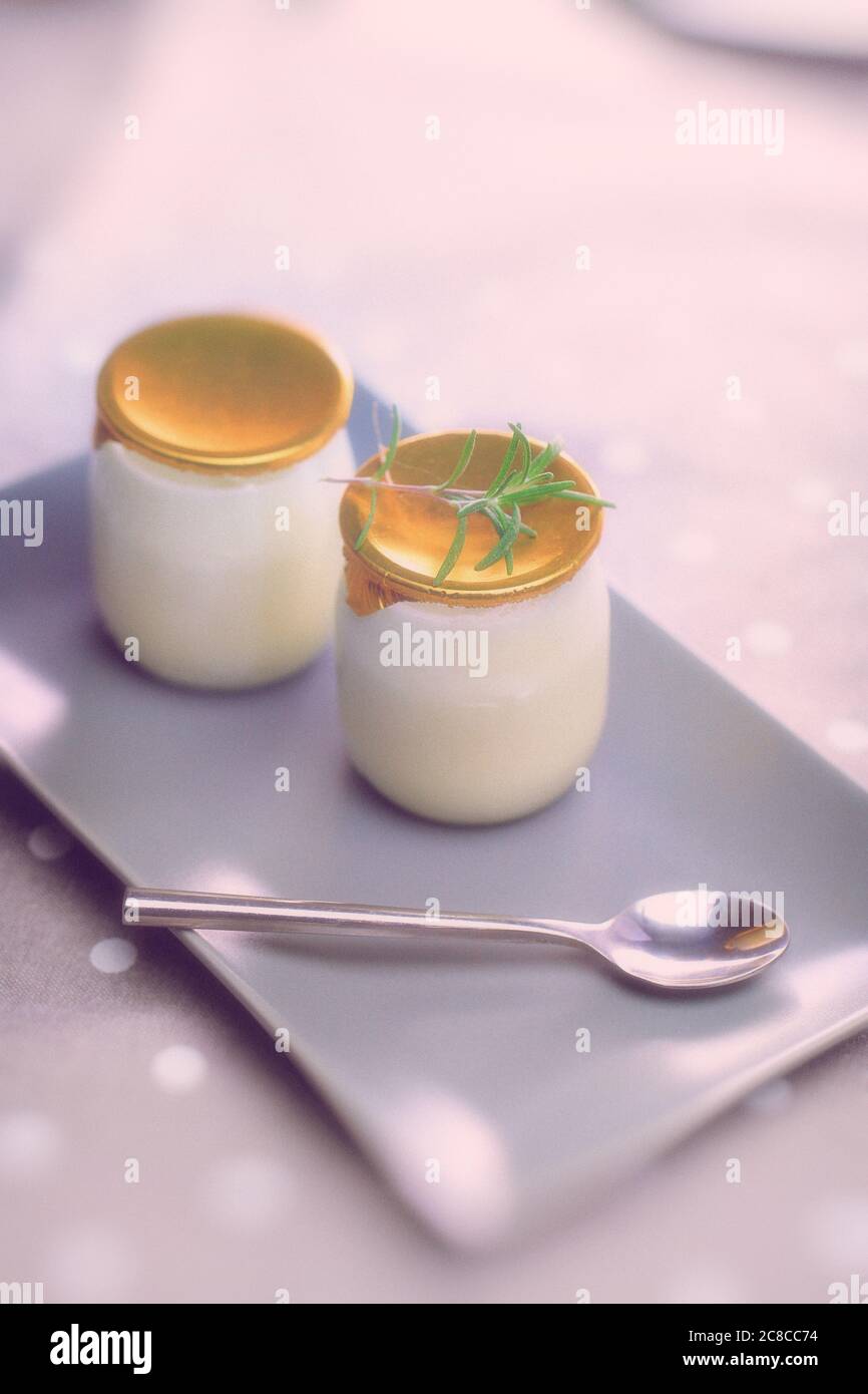Yogurt in a glass jar with a spoon. Healthy food for breakfast, dairy product Stock Photo