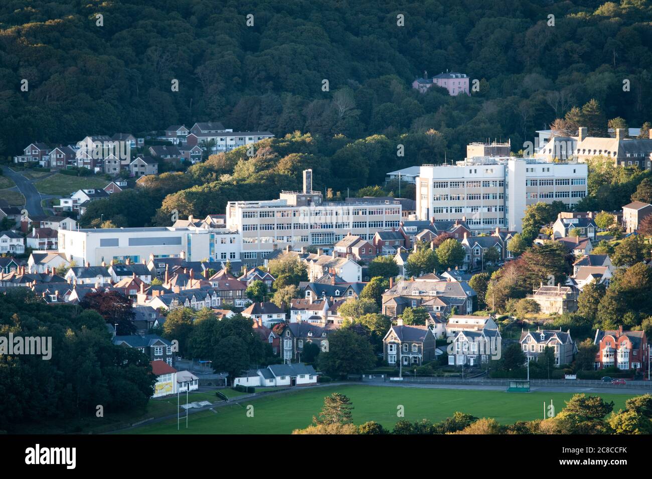 Bronglais General Hospital Aberystwyth, a landscape photograph showing the whole of the hospital from a high viewpoint in summertime. Stock Photo