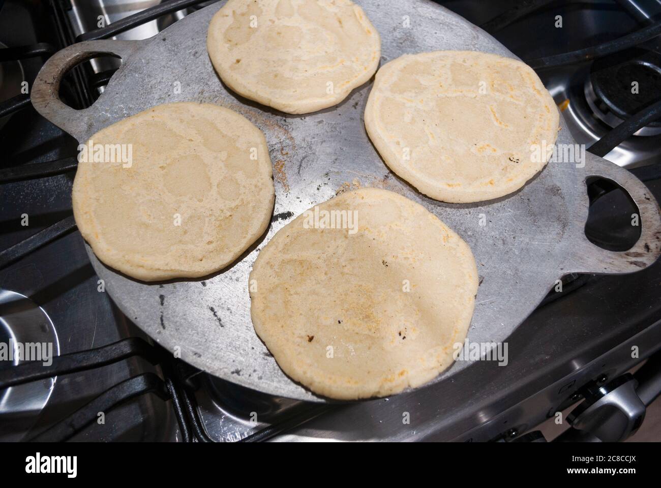 https://c8.alamy.com/comp/2C8CCJX/nutritious-handmade-corn-tortilla-cooked-on-a-metal-griddle-on-a-gas-stove-in-a-guatemalan-home-2C8CCJX.jpg