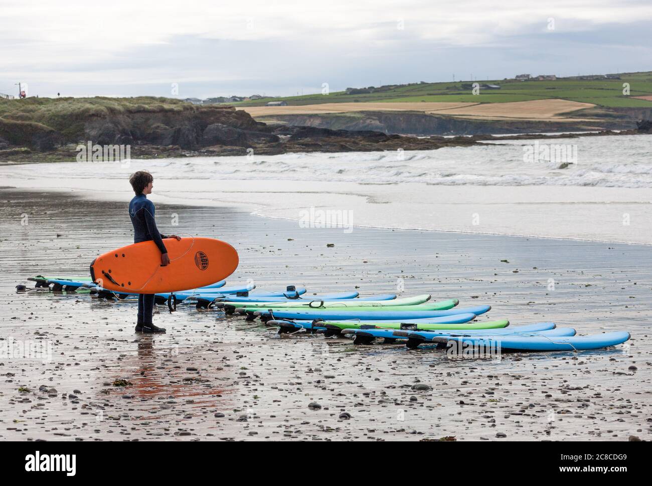 Garrettstown, Cork, Ireland. 23rd July, 2020. Finn Browne preparing the surf boards for the summer camp at the Pukana Surf School in Garrettstown, Co. Cork, Ireland. - Credit; David Creedon / Alamy Live News Stock Photo