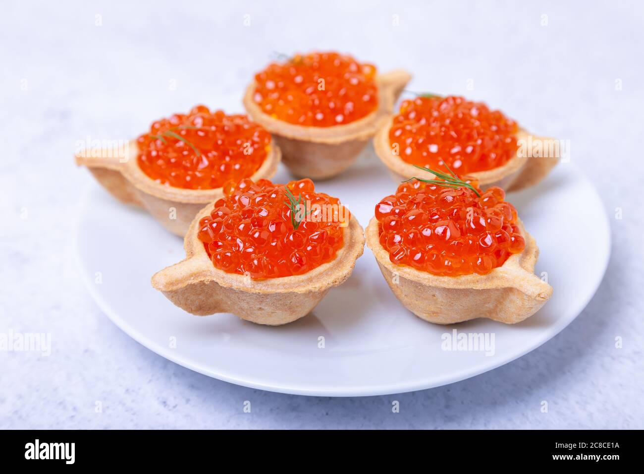 Red caviar (salmon caviar) in tartlets. Selective focus, close-up. Stock Photo