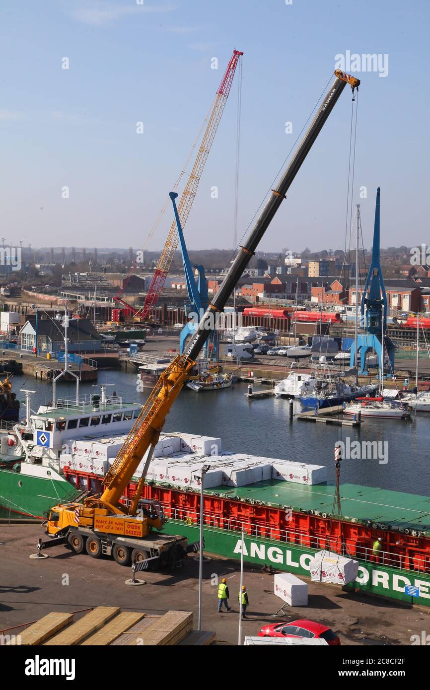 Timber ship being unloaded Stock Photo