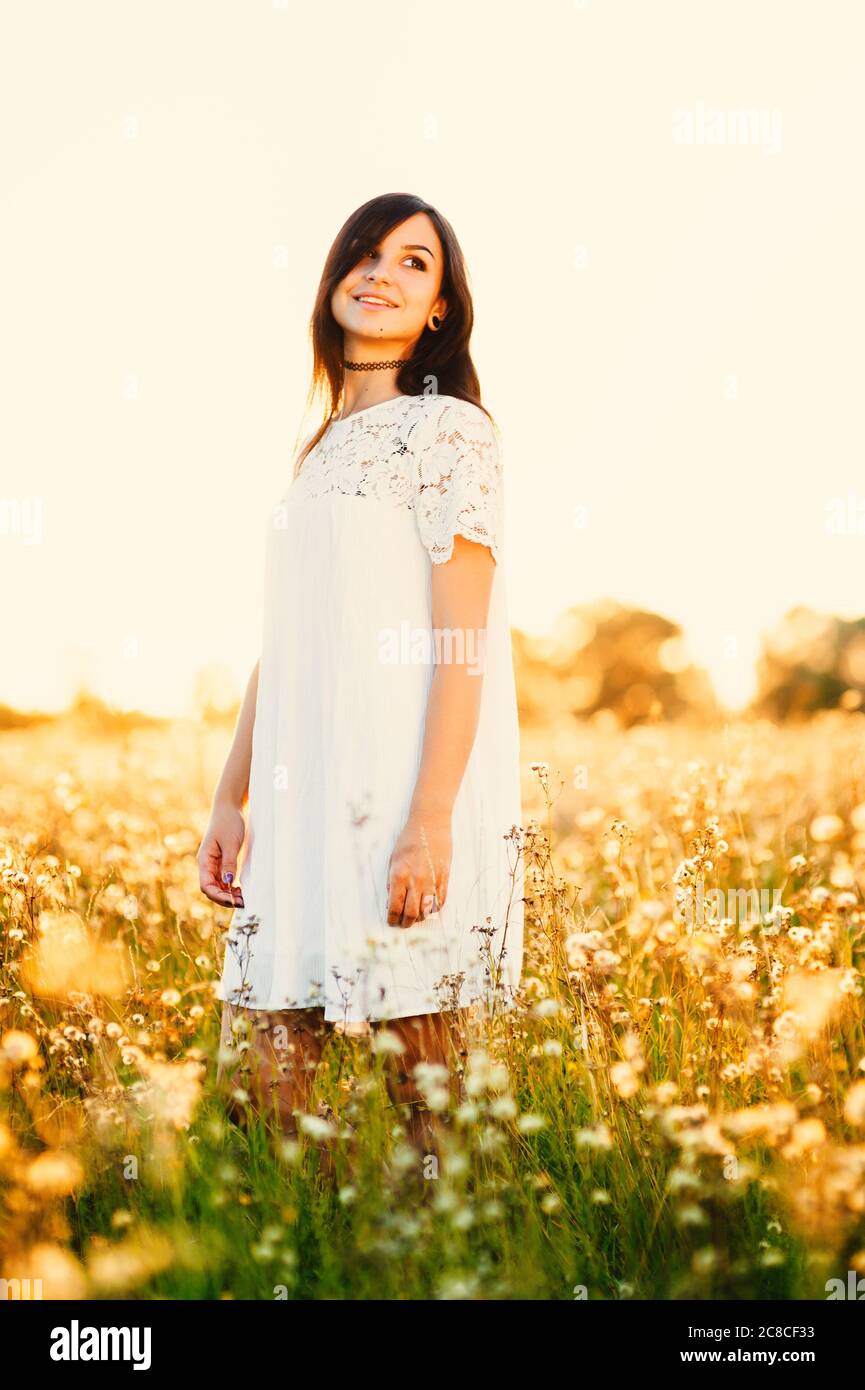 Beautiful Tender lovely young woman with long hair in flower field in ...