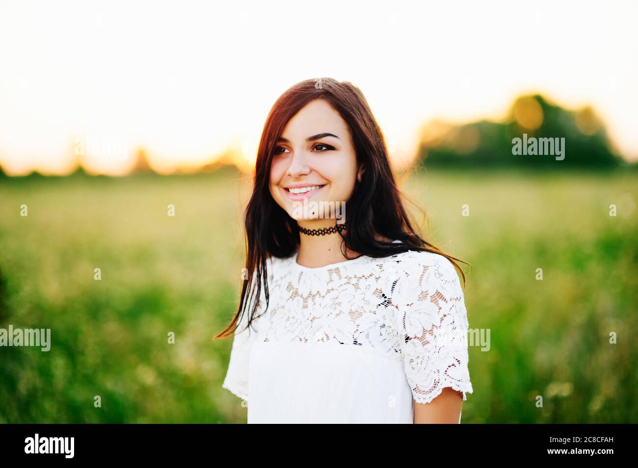 Beautiful Tender lovely young woman with long hair in flower field in ...