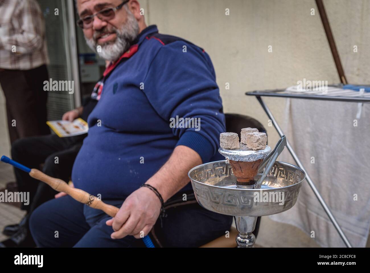 Man smoking shisha in Sin el Fil suburb east of Beirut in Matn District of Mount Lebanon Governorate, Lebanon Stock Photo