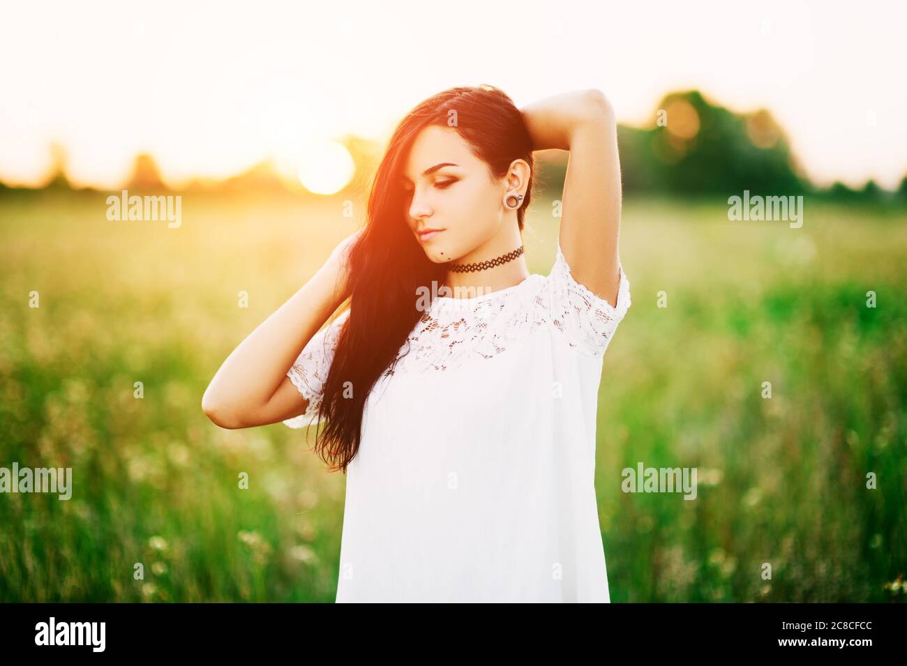 Beautiful Tender lovely young woman with long hair in flower field in ...