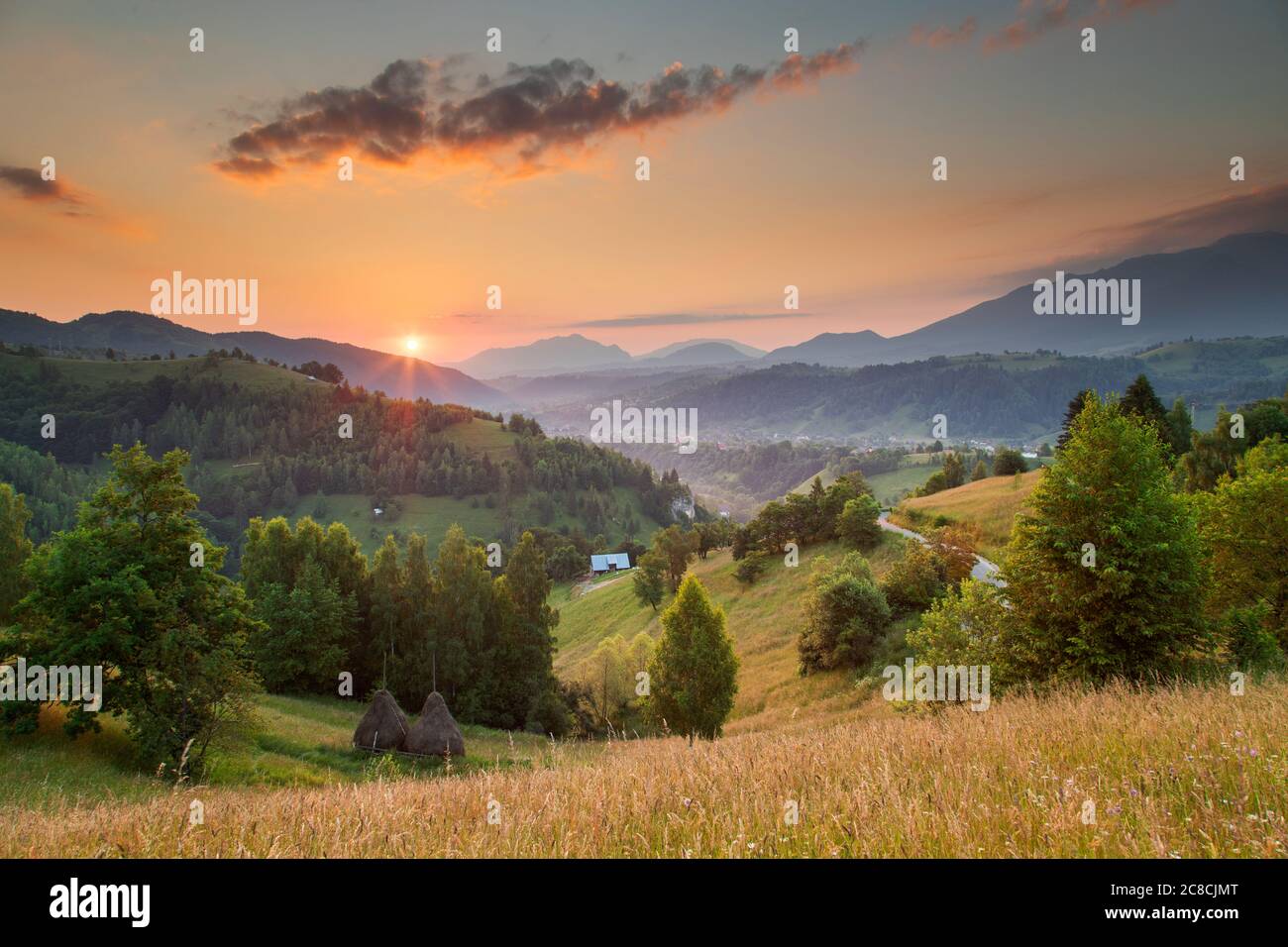 Summer sunrise in the Transylvanian village. Aerial foggy landscape in Transylvania, at sunrise Stock Photo