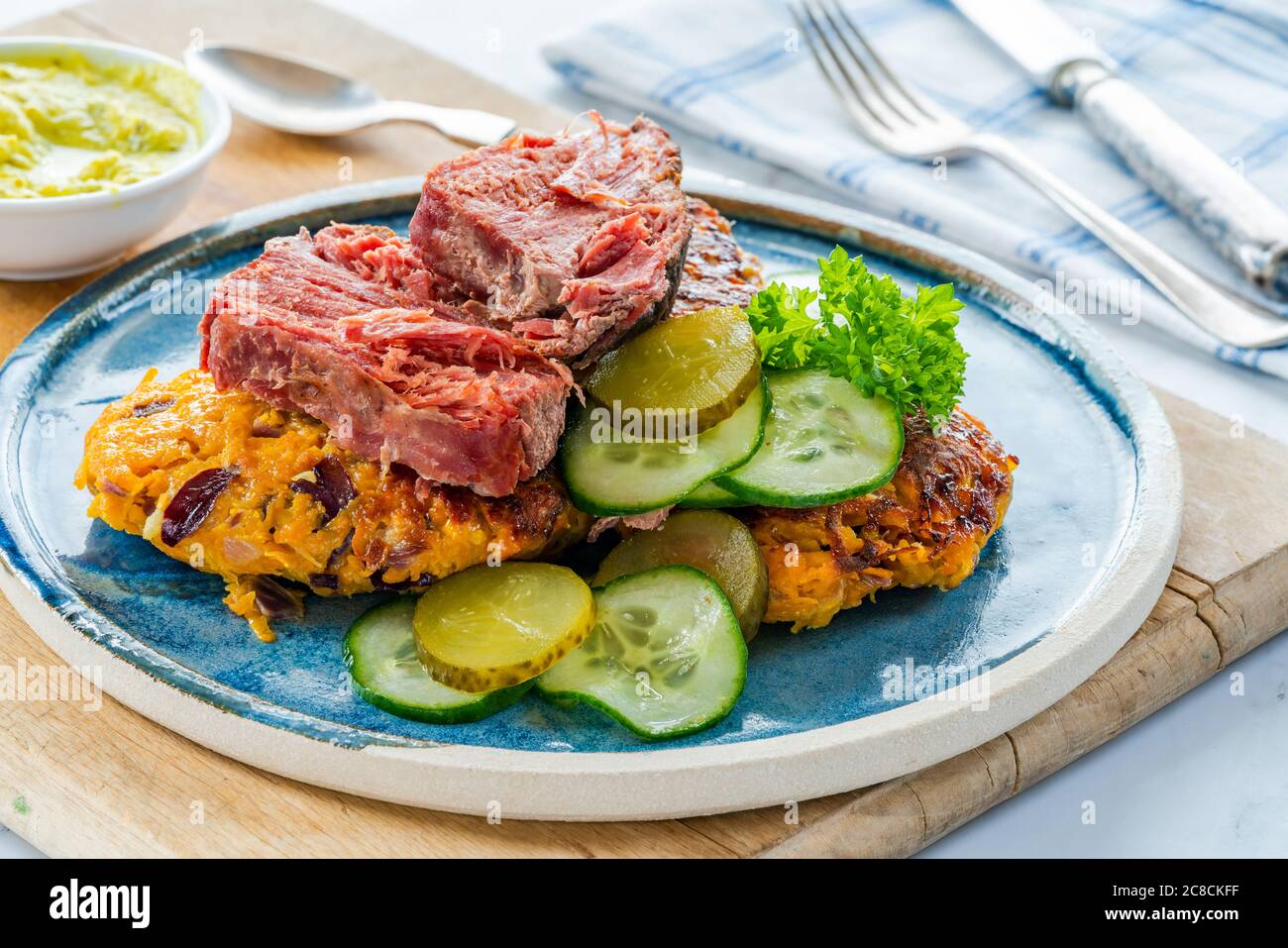Sweet potato latkes with sald beef, cucumber salad and mustard tartar sauce Stock Photo