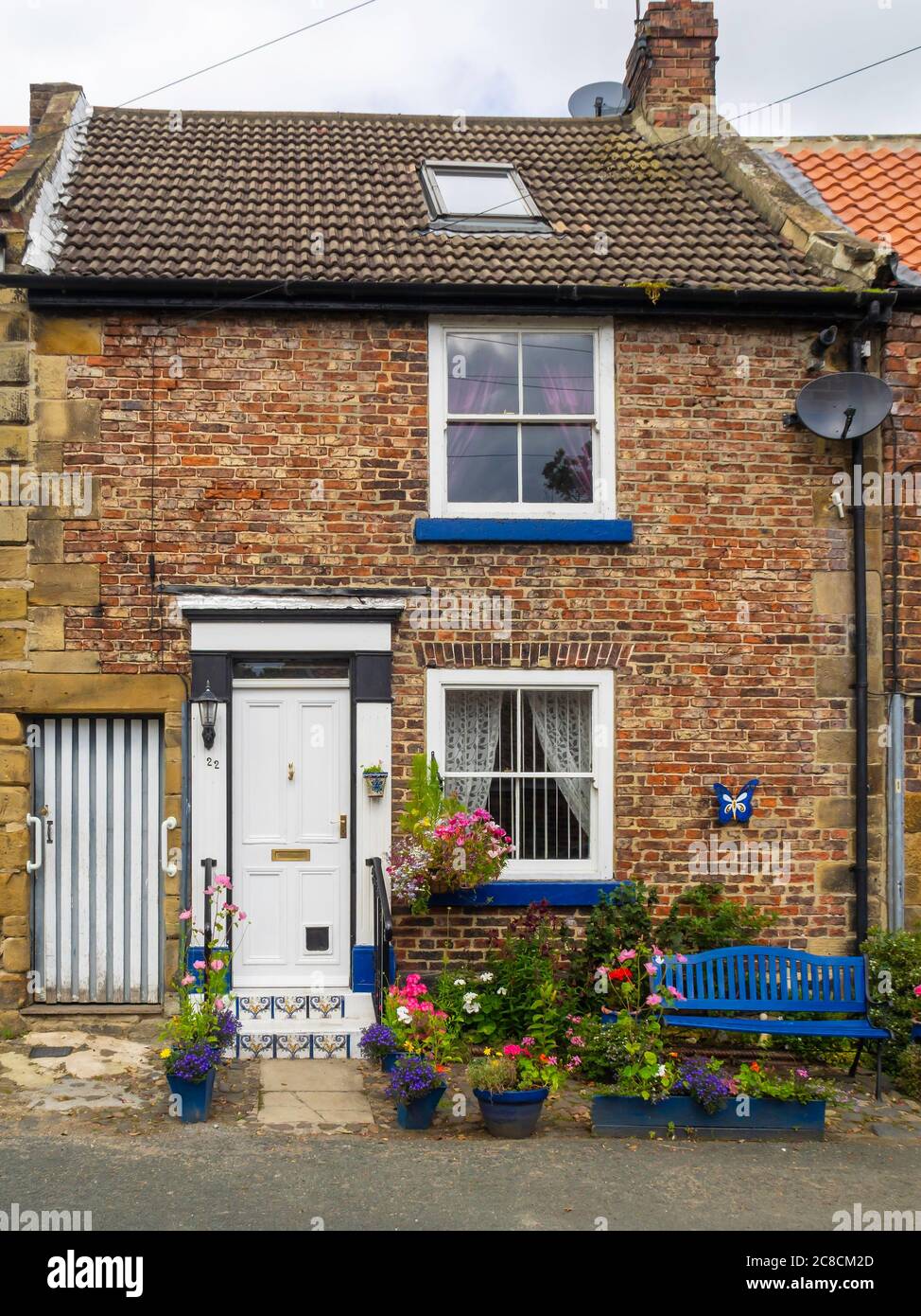 Historic terraced cottage and small garden beside the river Leven in Stokesley town centre North Yorkshire Stock Photo