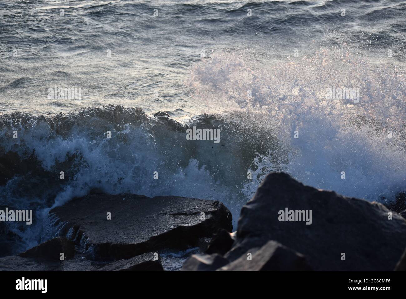Waves crash on rocks Stock Photo