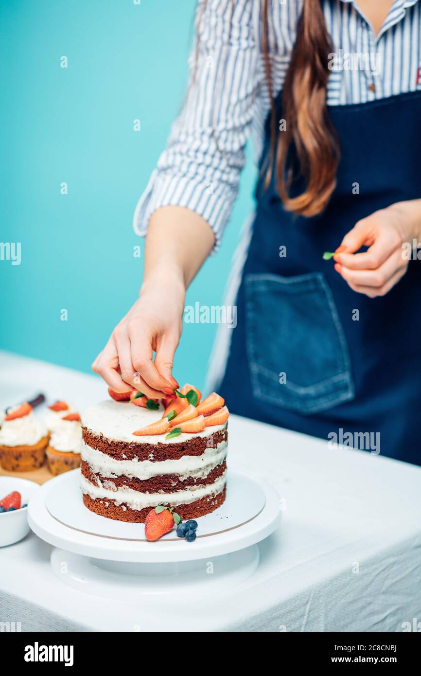 Step by step process of cooking cake on light blue background at cafe Stock Photo