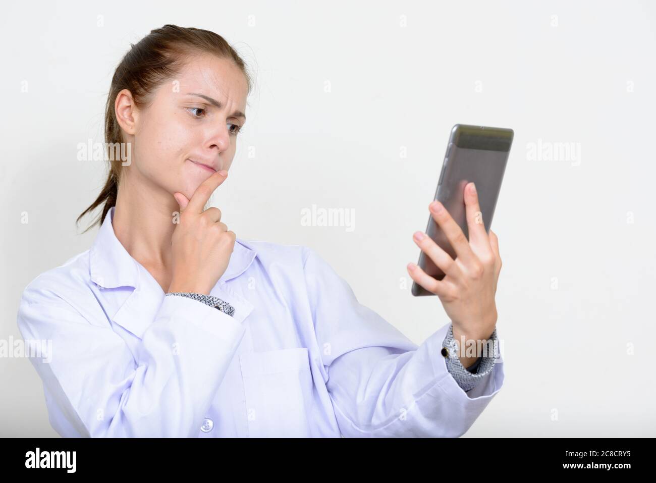 Portrait of young beautiful woman doctor against white background Stock ...