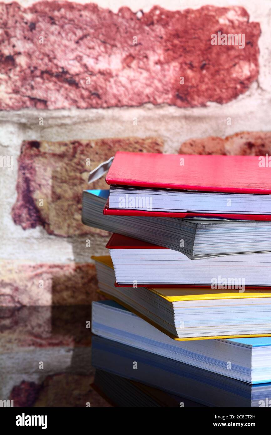 Stack of reading books on a glass table Stock Photo