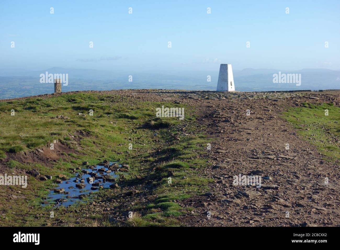 The Stone Waymarker & Concreate Triangulation Pillar (Trig Point) on the Summit of Pendle Hill on the Pendle Way Footpath from Barley, Lancashire, UK. Stock Photo