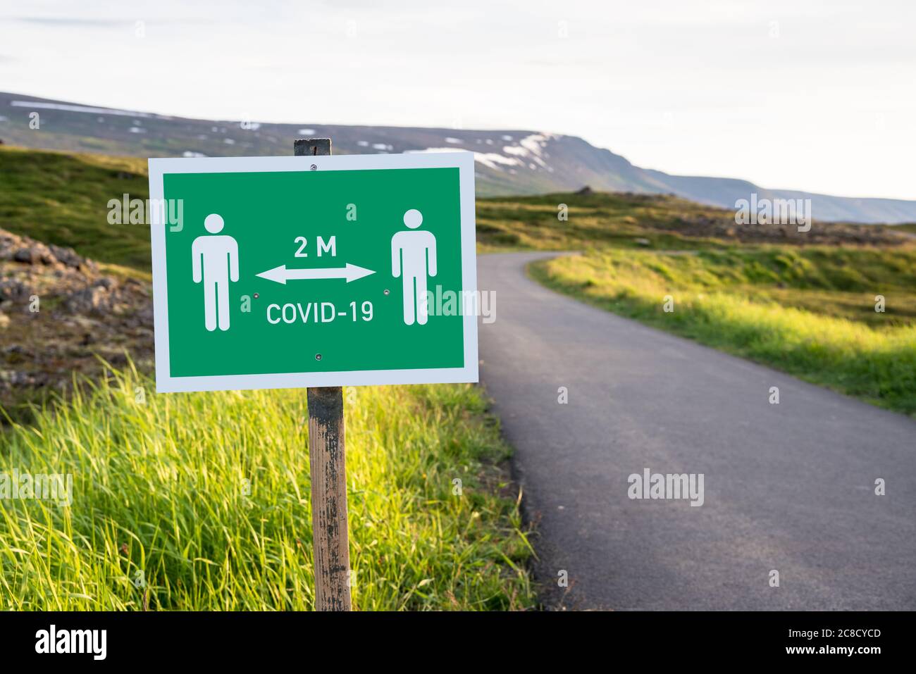 Social distancing sign along an empty path in a park in Iceland during the covid-19 pandemic Stock Photo