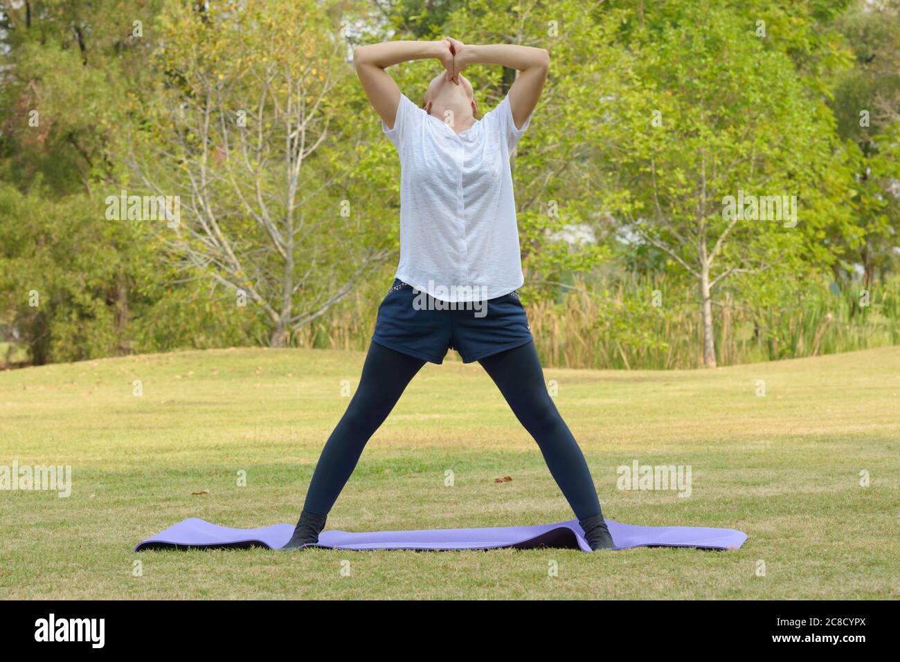 Young beautiful woman exercising at the park outdoors Stock Photo - Alamy