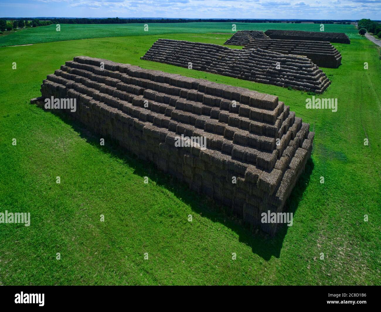 Aerial view of big pyramids made out of rectangular haystacks Stock Photo