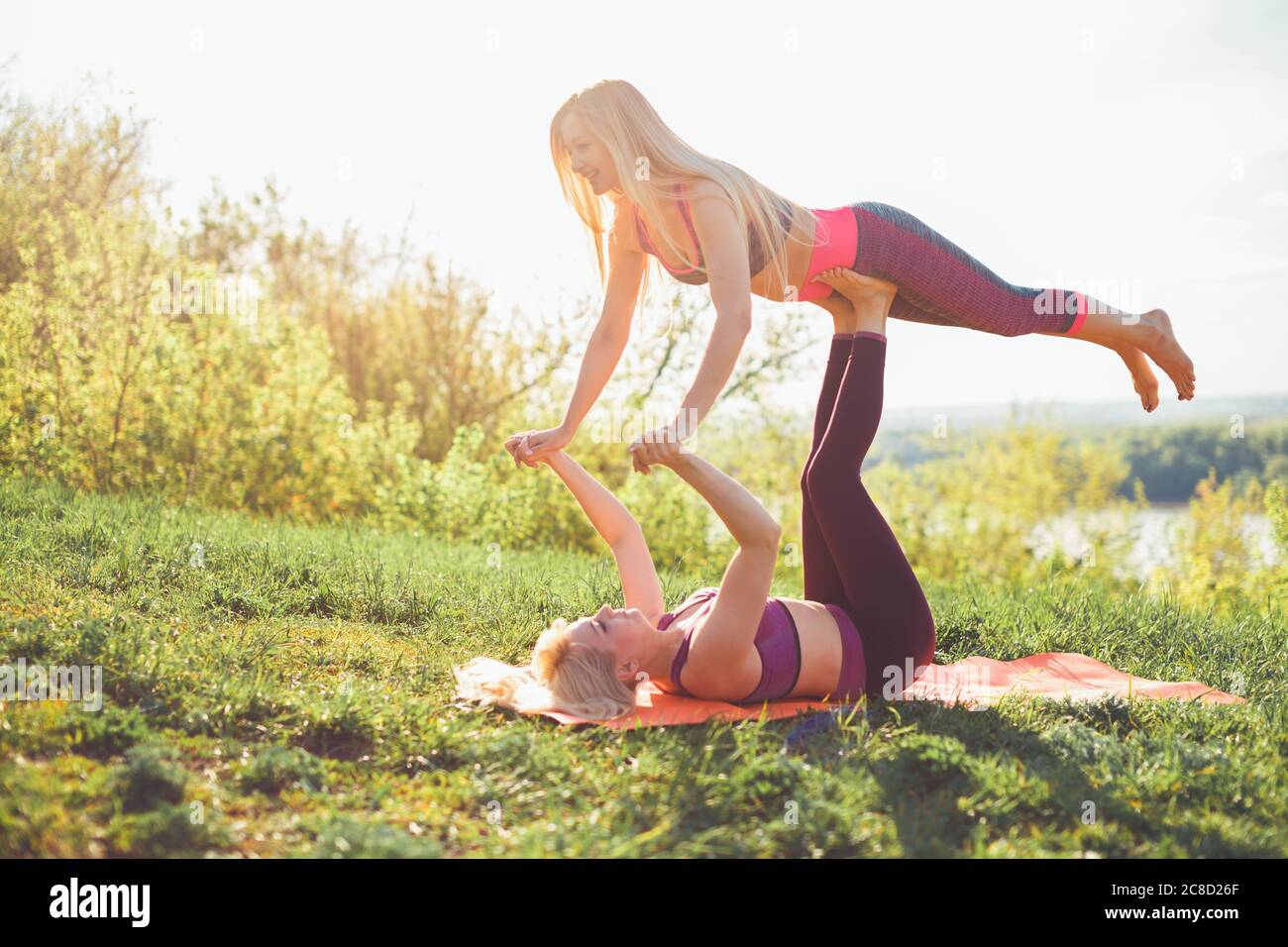 two women contorsionist practicing gymnastic yoga outdoor Stock Photo