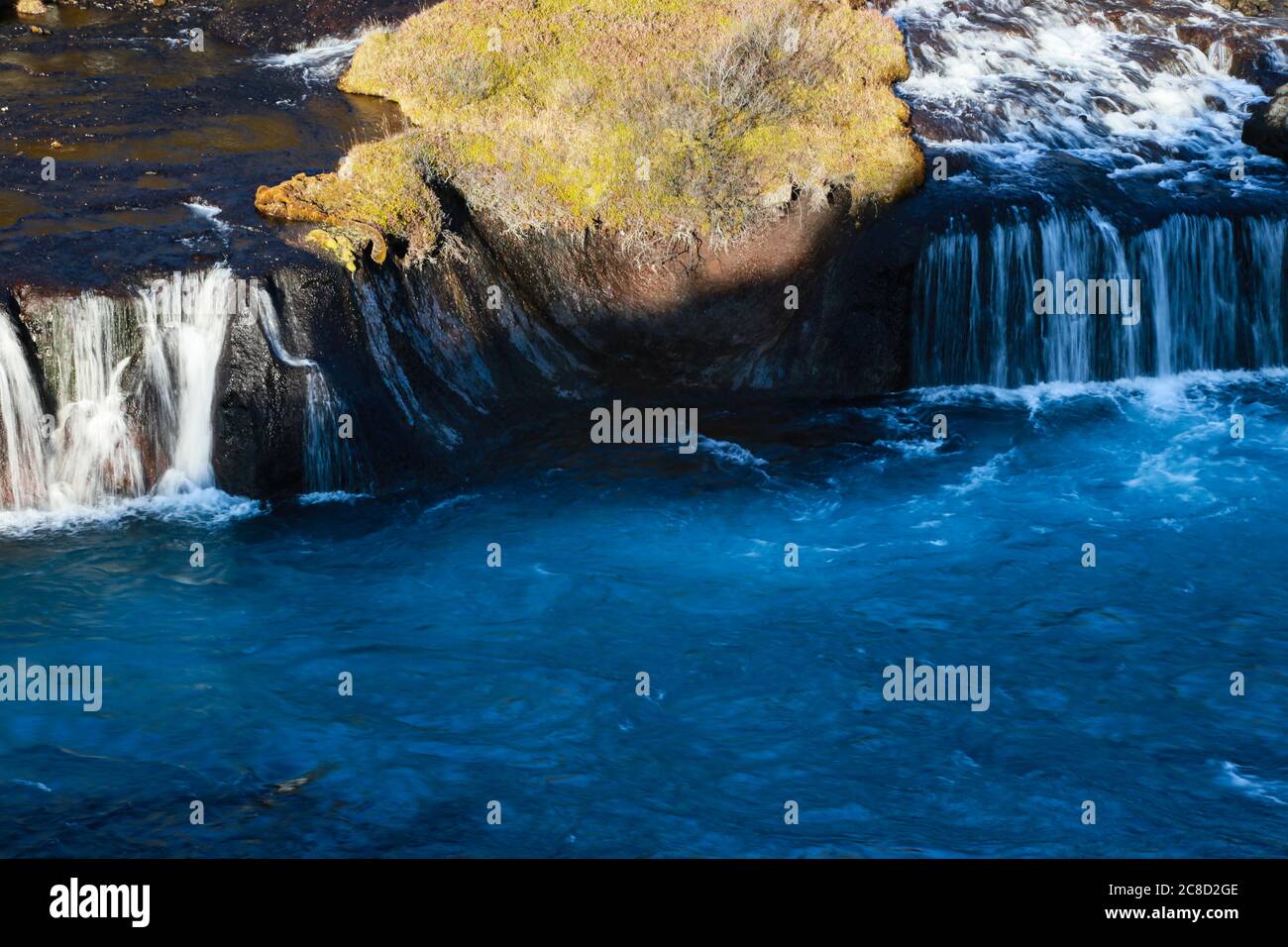 Bjarnafoss waterfall in Iceland, coming from underneath a great lava plain. Lovely colours of blue. Stock Photo