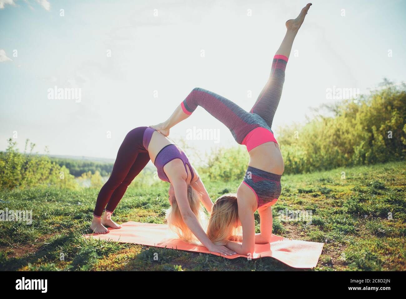 two women contorsionist practicing gymnastic yoga outdoor Stock Photo