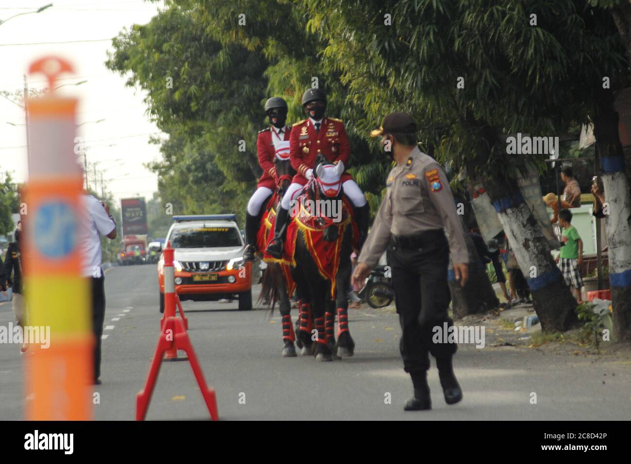 Madiun, Indonesia. 21st July, 2020. Police Director of the Animal Corps Samapta Bhayangkara Republic of Indonesia National Police Security Maintenance Agency Brigadier General Hariyanto [front] riding a 13-year-old Friesian horse from the Netherlands during a patrol to the Dolopo Police Station in Madiun District. Police Brigadier General Hariyanto conducted a patrol accompanied by a female police officer namely the Animal Police from the Detachment Turangga of the Republic of Indonesia State Police, Bella A (Photo by Ajun Ally/Pacific Press/Sipa USA) Credit: Sipa USA/Alamy Live News Stock Photo