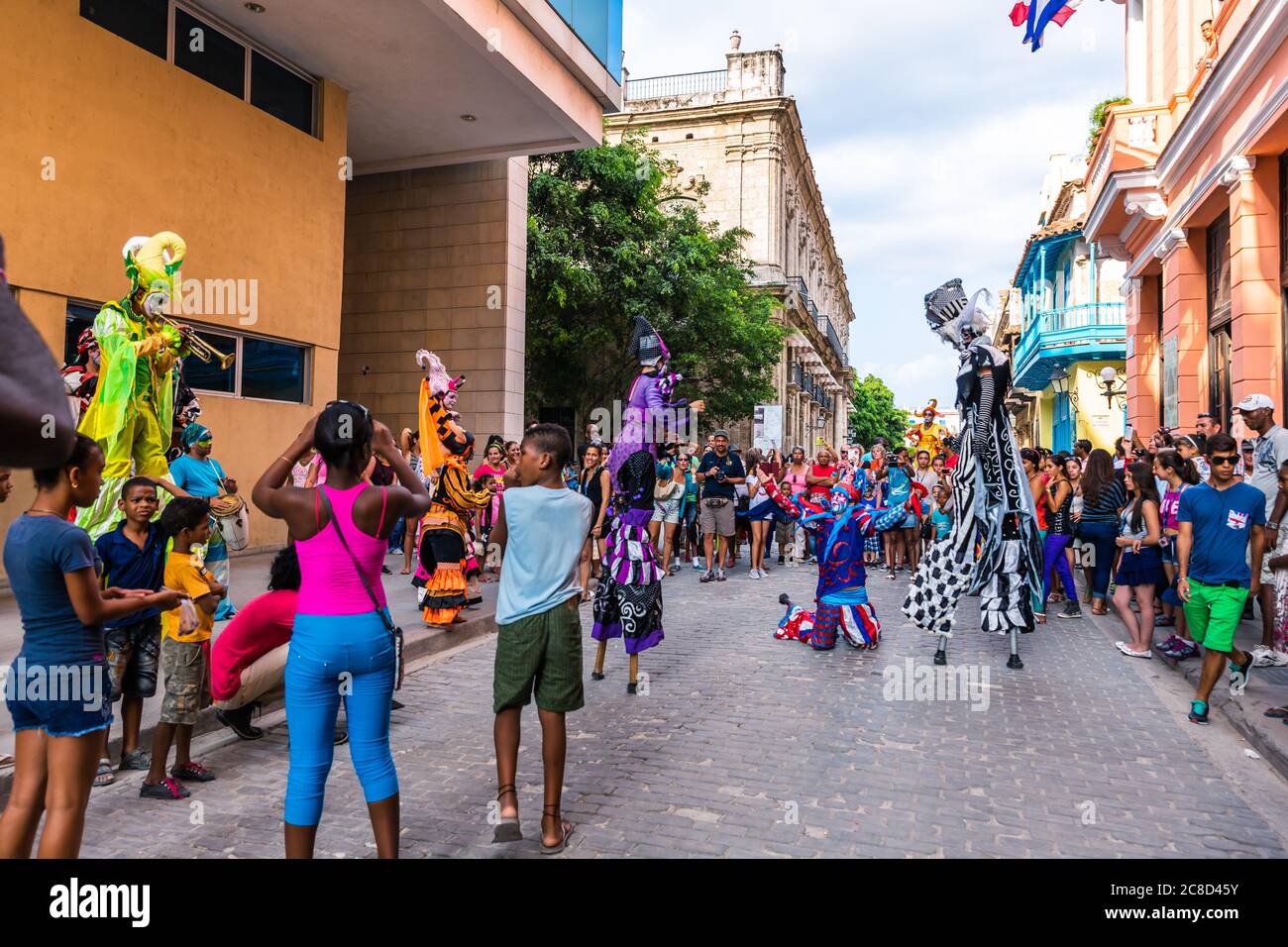 Havana / Cuba - 04.16.2015: Colorful stilt walkers dancing during the International Festival of Dance in Urban Landscapes 'Old Havana, City in Motion' Stock Photo