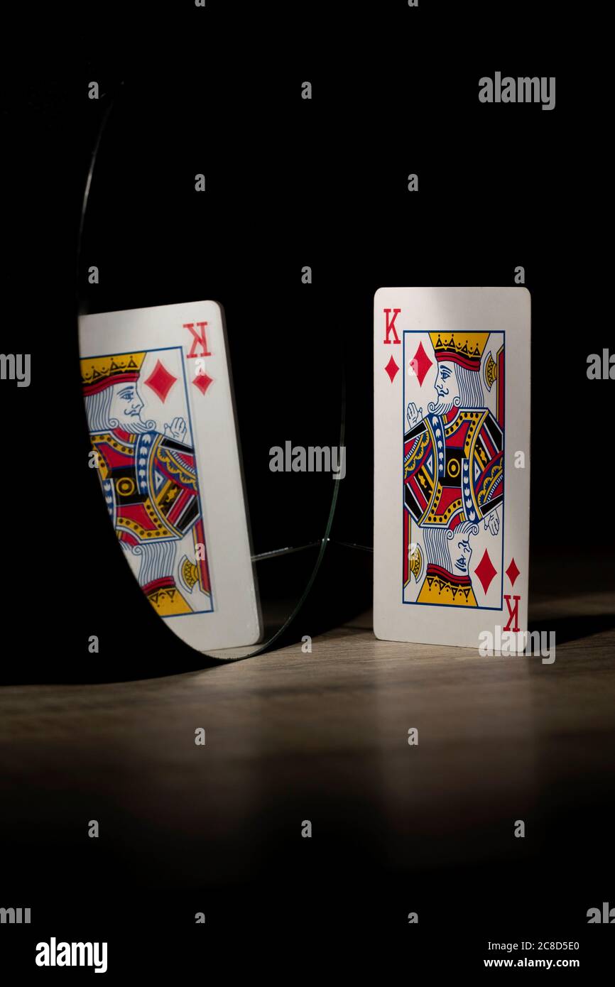 Brecht, Belgium - 29 may 2020: The diamond king of a deck of playing cards looking at its own reflection in the mirror. Normally it looks like pride a Stock Photo