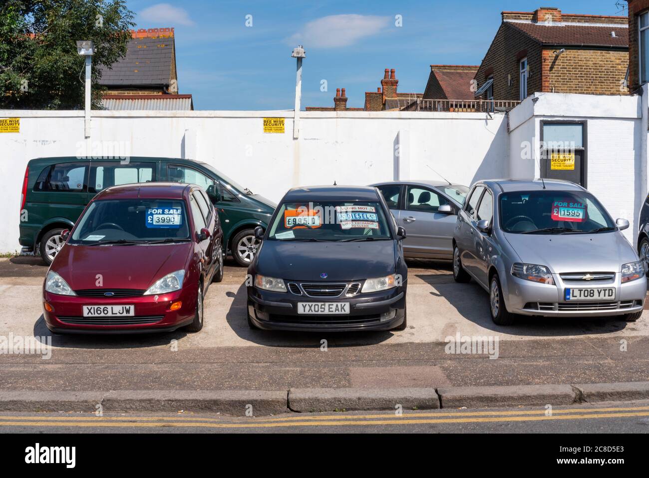 Back street outdoor car lot, vehicle sales in Westcliff on Sea, Southend, Essex, UK. Budget cars for sale. Old, ageing vehicles. Saab. Ford Stock Photo