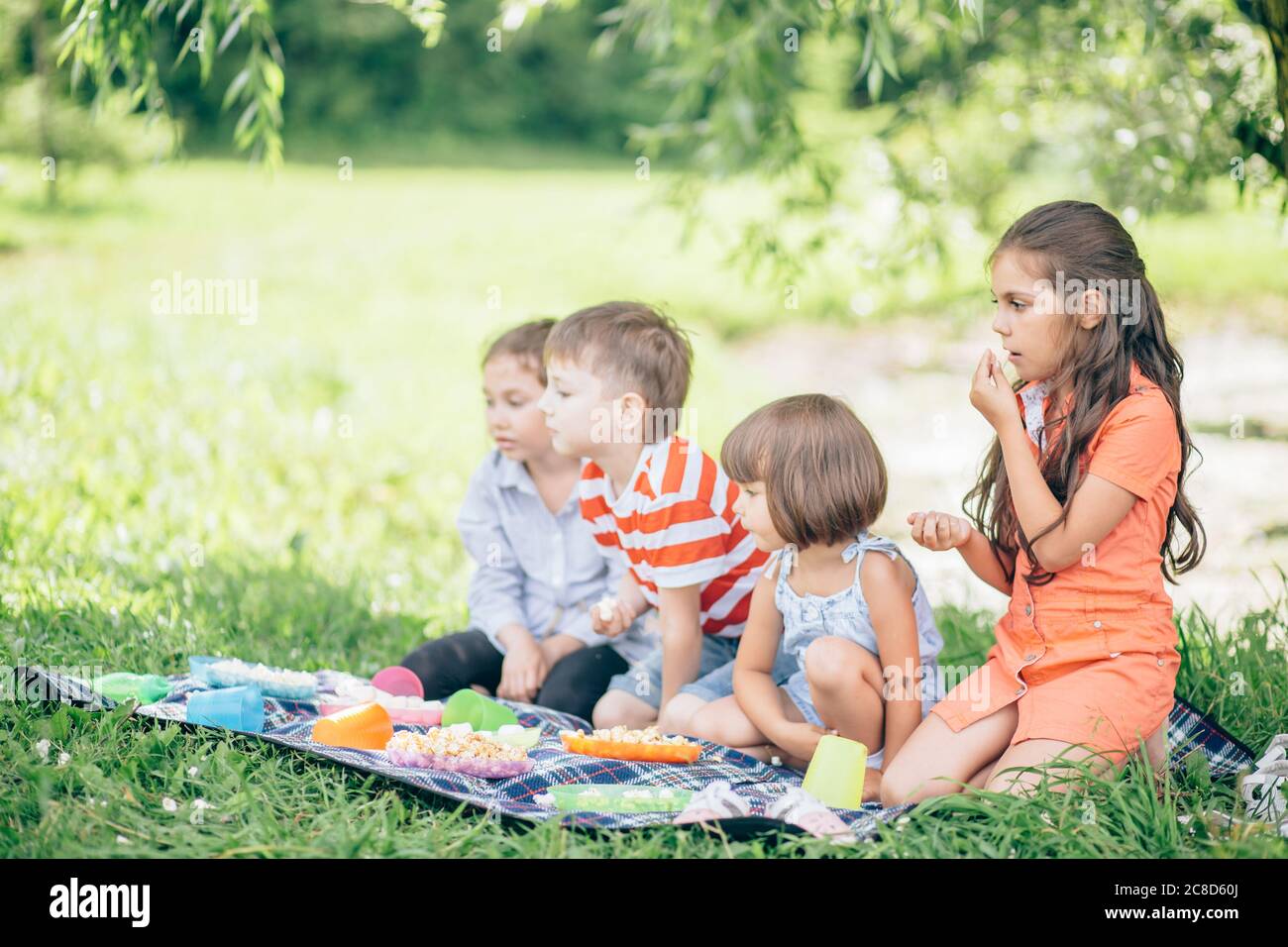 Three happy smiling child playing in park Stock Photo