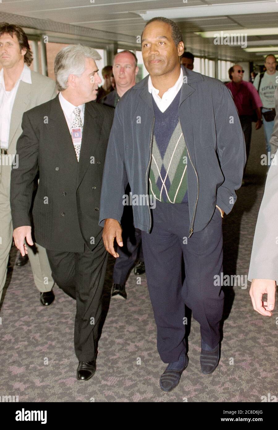 Former professional American football player O J Simpson arriving at London's Heathrow Airport in 1996 for a publicity tour in the U.K. with British publicist Max Clifford following his acquittal of the murders of his former wife, Nicole Brown Simpson, and her friend, Ron Goldman. Stock Photo