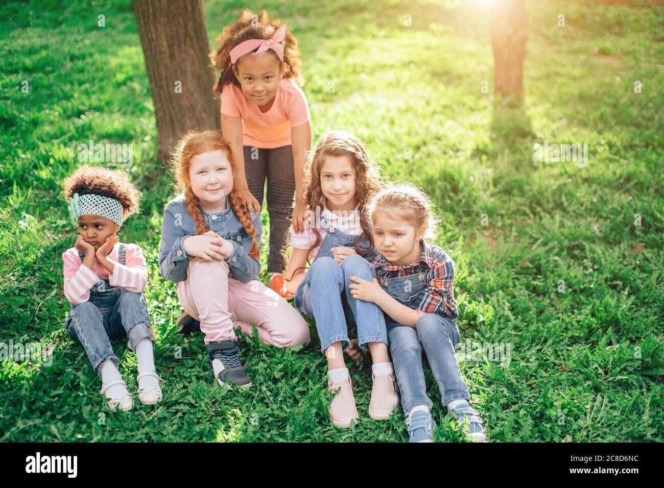 a group of girls playing outdoors. the concept of a happy childhood and ...