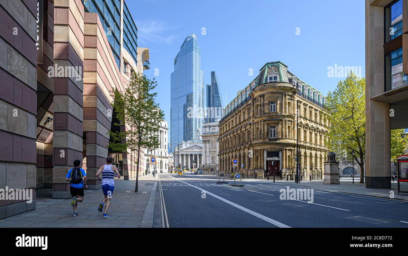 Two Runners on Empty Streets. City of London street in the Financial District Stock Photo