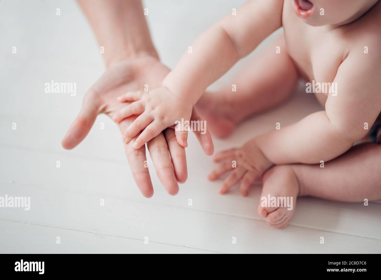 Father holds his little baby feet close up Stock Photo