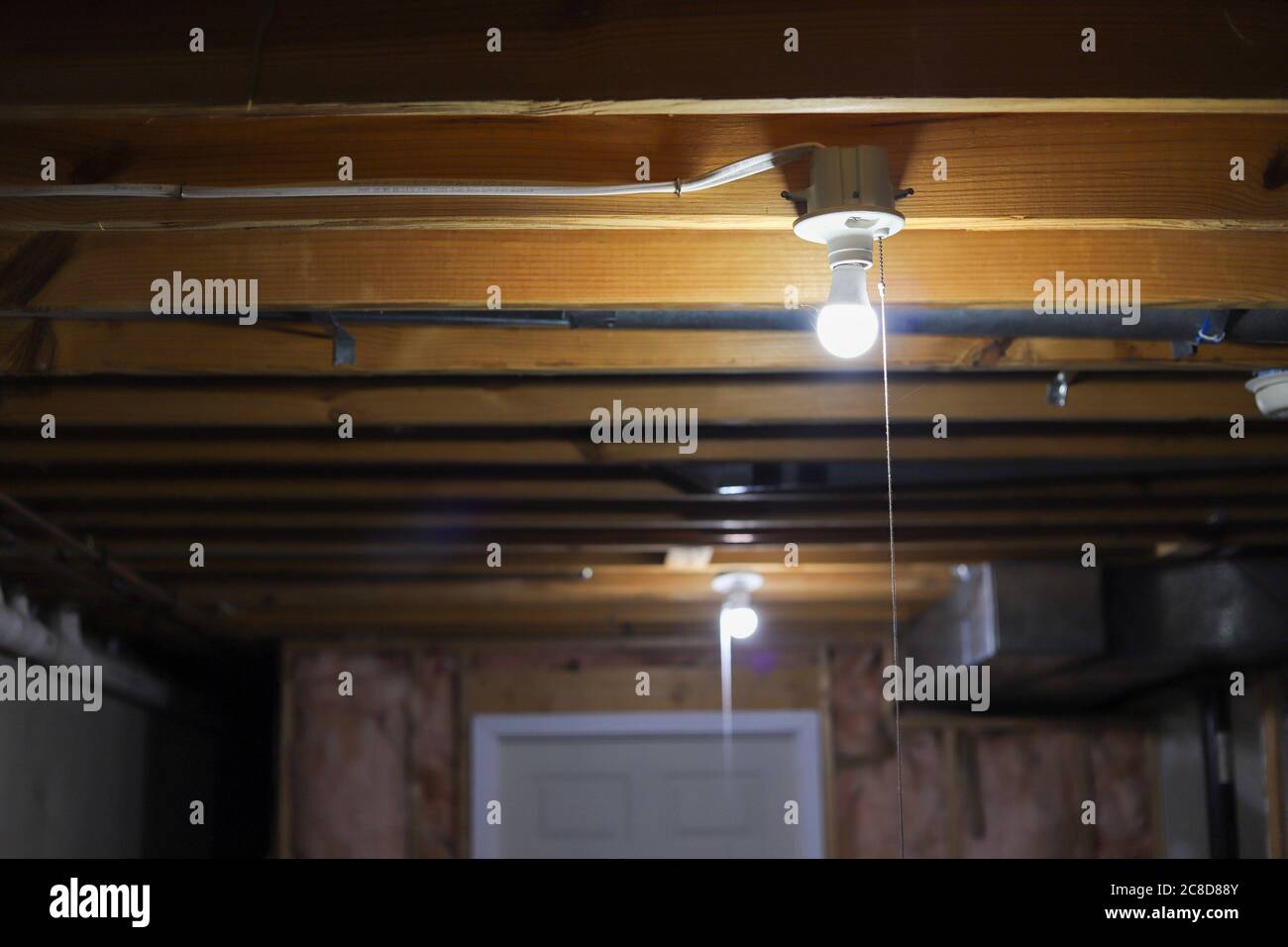 A Lightbulb In A Basement Ceiling Stock Photo Alamy