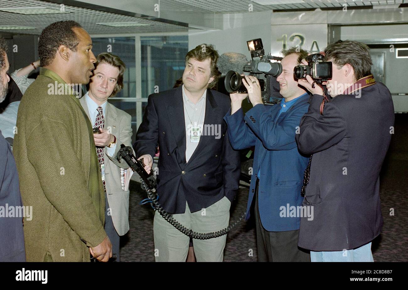 Former professional American football player O J Simpson speaking to the media at London's Heathrow Airport in 1996 following a publicity tour in the U.K. after his acquittal of the murders of his former wife, Nicole Brown Simpson, and her friend, Ron Goldman in 1996. Stock Photo