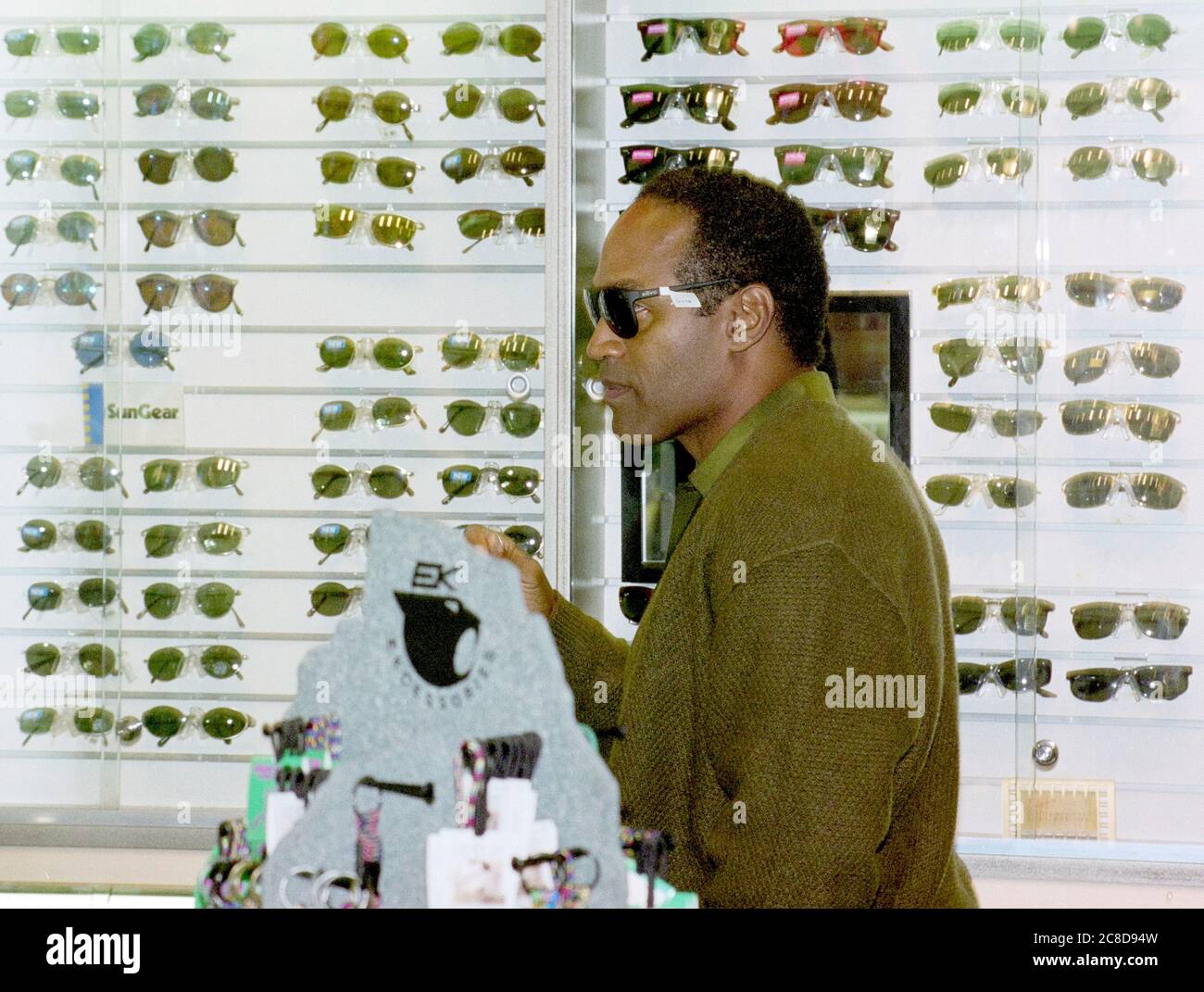 Former professional American football player O J Simpson shopping for sunglasses at London's Heathrow Airport in 1996 following a publicity tour in the U.K. after his acquittal of the murders of his former wife, Nicole Brown Simpson, and her friend, Ron Goldman in 1996. Stock Photo