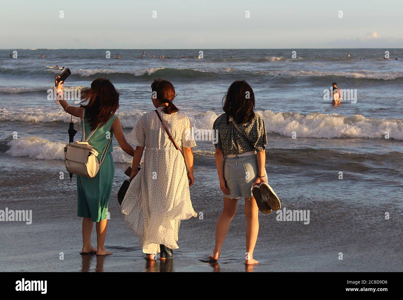 Three Women taking a selfie on Kamakura beach in Japan. Stock Photo