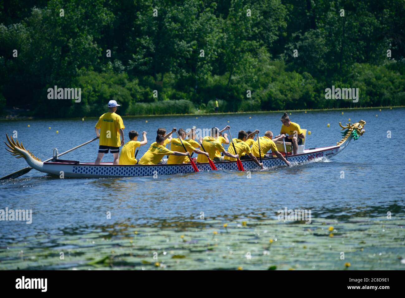 Oarsmen rowing a dragon boat on a river. Kiev oblast championship among amateurs Stock Photo