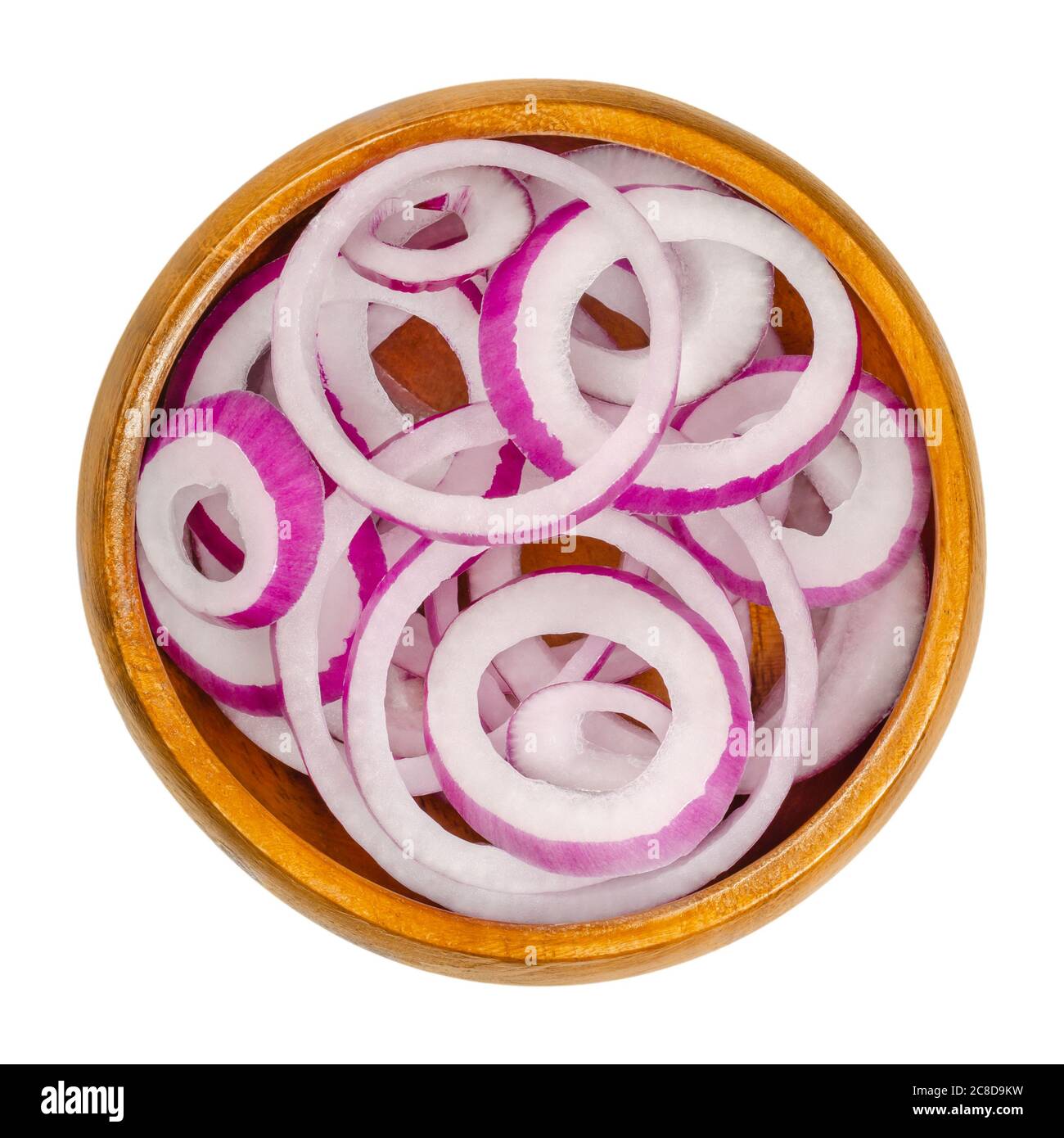Red onion rings in wooden bowl. Slices of the onion cultivar Allium cepa with purplish red skin and white flesh tinged with red. Closeup. Stock Photo