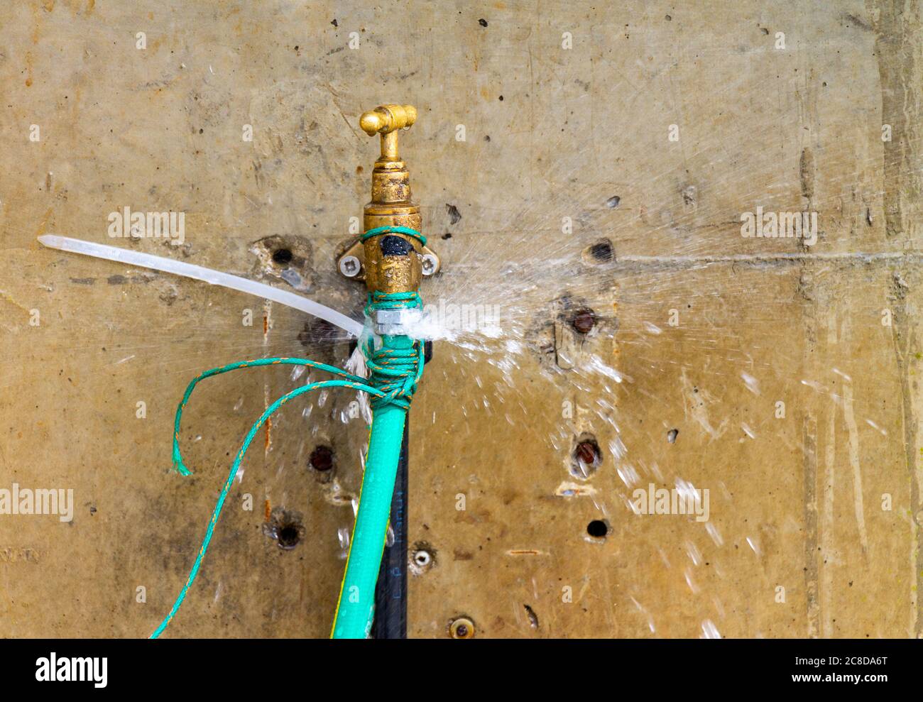 Leaking fresh water tap leaking hose pipe Stock Photo