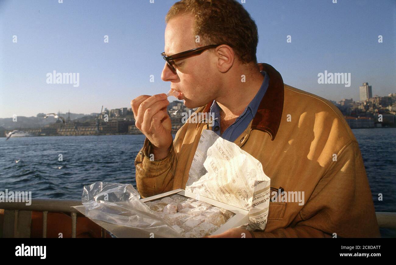 British Journalist and Author John Diamond on a weekend visit to Istanbul Turkey 1989 Eating Turkish delight Stock Photo