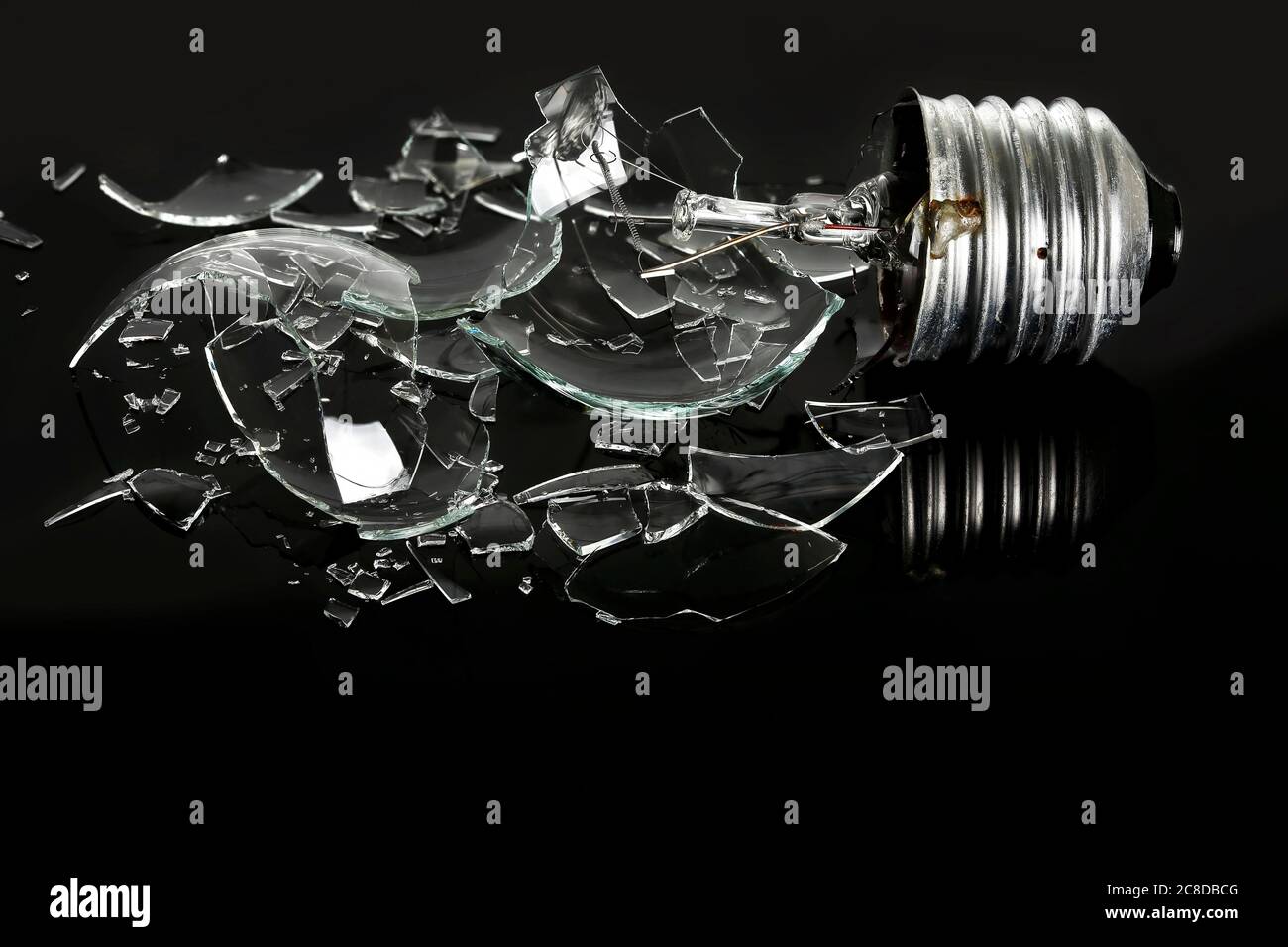 smashed light bulb on black background Stock Photo Alamy
