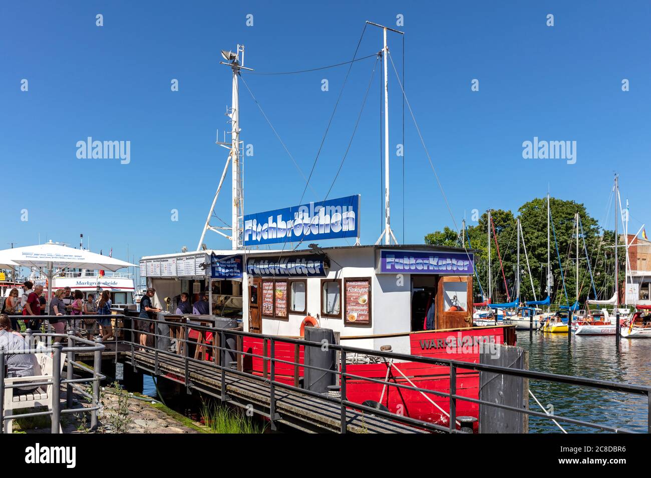 fish bar ‘Futterkutter’ at the canal called ‘Alter Strom’ (Old Channel) in the Warnemünde district of the city of Rostock in Mecklenburg, Germany Stock Photo