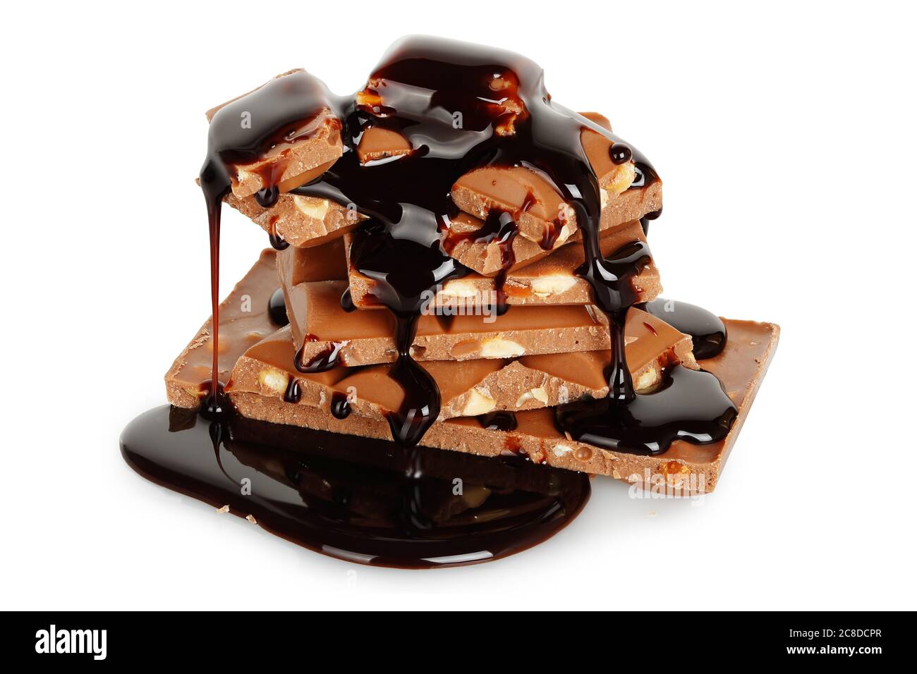 chocolate syrup being poured on chocolate pieces isolated Stock Photo