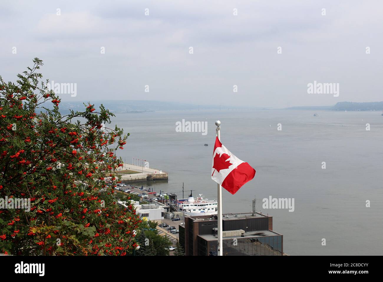 Canadian flag hissed at Quebec City shore. Stock Photo